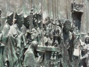 Religious door drama in bronze